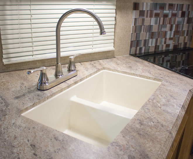 Clean sink surrounded by countertop.