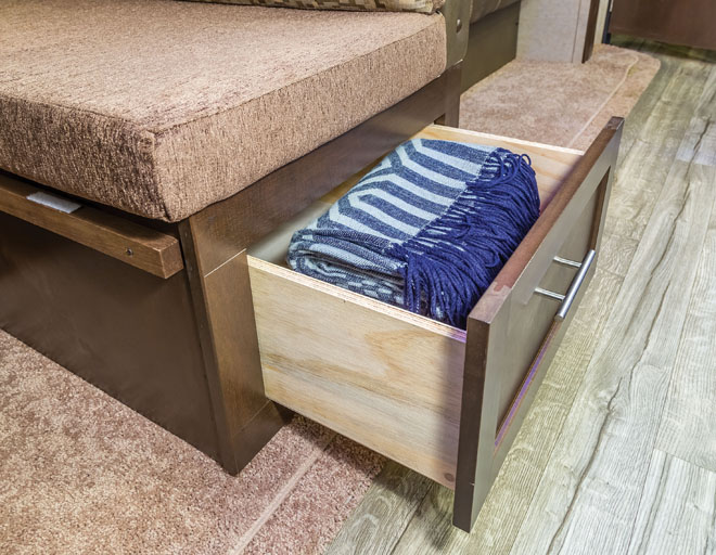 RV bedroom shows a drawer beneath the bed.